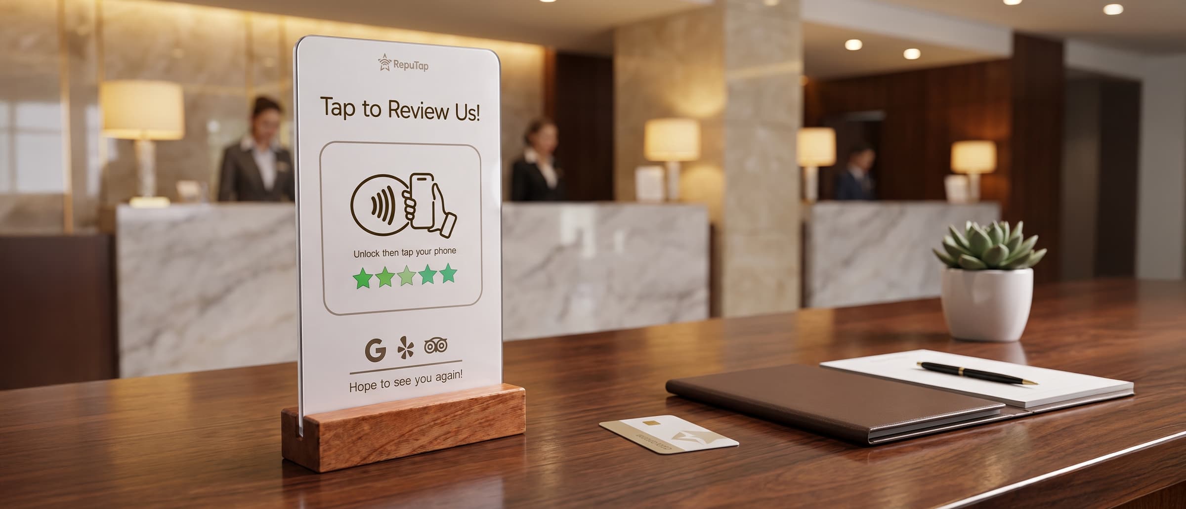 A RepuTap Tap to Review Us stand on a hotel front desk next to a room key card
